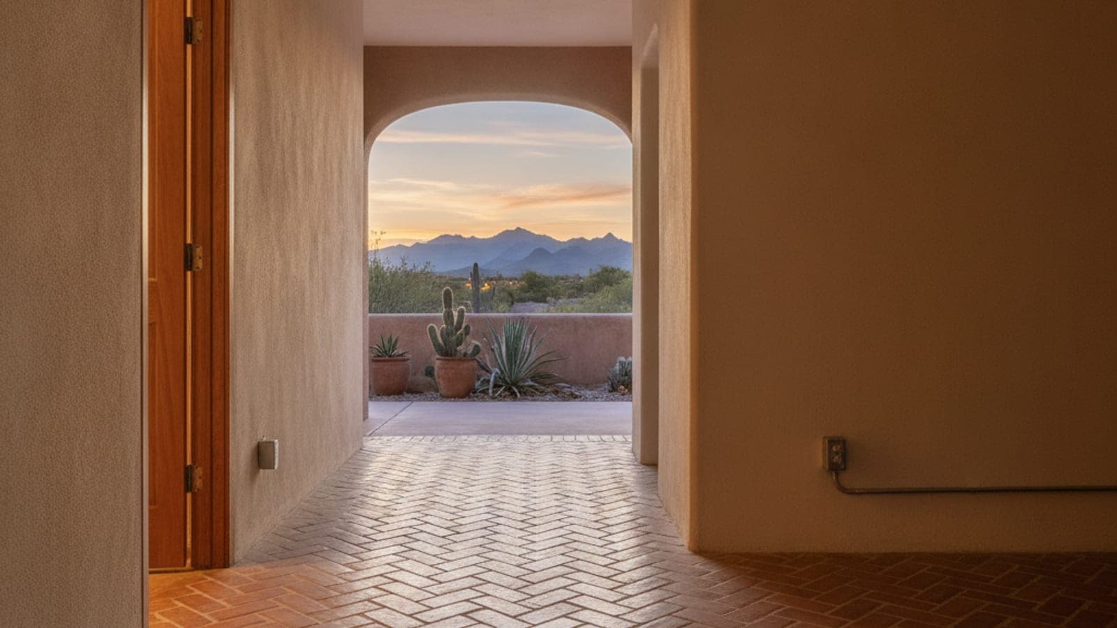 Rejilla de piso en una casa de Tucson con loseta de terracota y la puerta de una casita al fondo